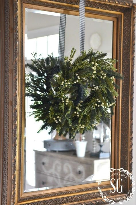 CREATIVE WAYS TO USE CHRISTMAS WREATHS-wreath hanging on mirror-stonegableblog.com Christmas Wreath On Mirror, Wreaths On Mirrors, Wreath Hanging Ideas, Wreath Over Mirror, Oval Mirror Decor, Christmas Mirror Decorations, Wreath On Mirror, Mirrors Ideas, Wreath Mirror