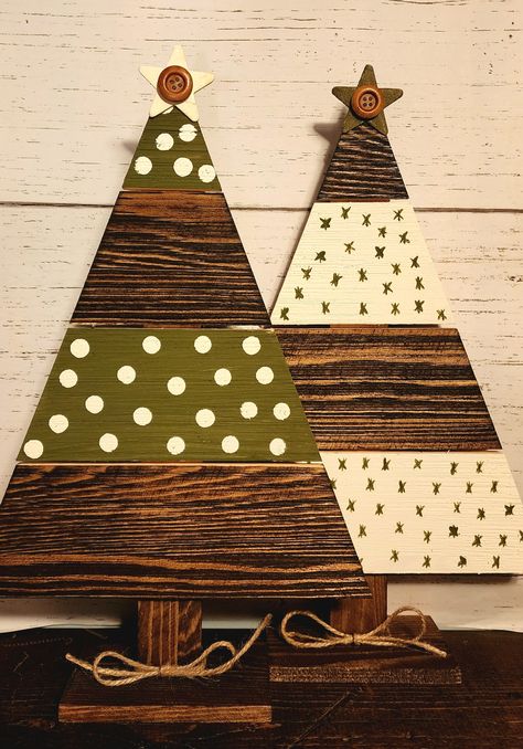 Hand painted wooden plank Christmas trees. 14.5 inches high by 9.5 inches wide. Choose between green polka dot, white with green stars, or a set of two that includes one of each color. Finished with a star with button and a twine bow at the base. Painted Wood Trees Christmas Decorations, Decorating Wood Christmas Trees, Rustic Wood Christmas Tree, Painted Wooden Trees, Wood Pallet Christmas Tree, Painted Wood Christmas Trees, Wood Plank Projects, Wood Christmas Tree Ideas, Reclaimed Wood Christmas Decor