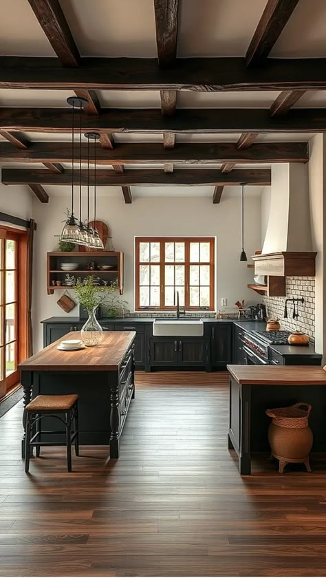 Rustic kitchen with wooden beams, dark cabinetry, central island, and natural light from large windows. Dark Wood Floors Black Cabinets, Kitchen Cabinets With Dark Wood Floors, Big Dark Kitchen, Timeless Wood Kitchen, Black Kitchen Cabinets With Wood Counter, Kitchen Remodel Dark Floors, Kitchen Ideas Dark Floors, Dark Wood Room Aesthetic, Slate Countertop Kitchen