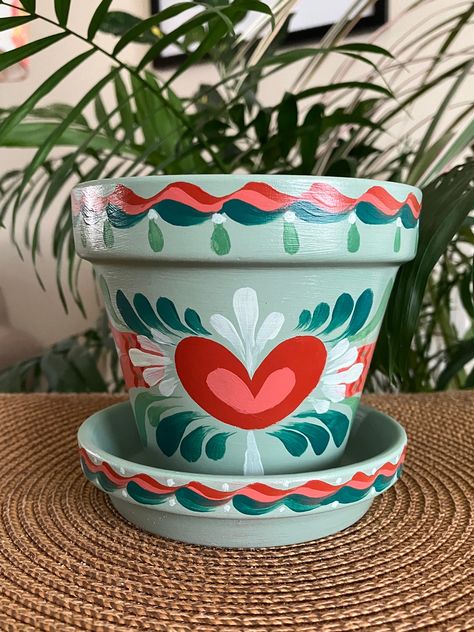 Hand Painted with Love, This 4" planter is perfect for your home or garden decor. The succulent green pot is adorned with greens, reds, pinks and white. Reminds me of watermelon colors.  Add a house plant, succulent, herb, or some seasonal flowers to this pot for a great gift! -4" Terra Cotta Pot with matching Saucer -Sealed with Satin Gloss Varnish to protect from dust, moisture, and discoloring.  Everything is hand painted and one of a kind.  I offer custom made pots and planters in my store i Tim Can Planters, Diy Painting Flower Pots, Fairy House Pot, Cute Planters Pots Diy, Painted Pots Diy Ideas, Mexican Painted Pots, Succulent Pot Painting, Planter Pot Painting Ideas, Diy Painted Plant Pots