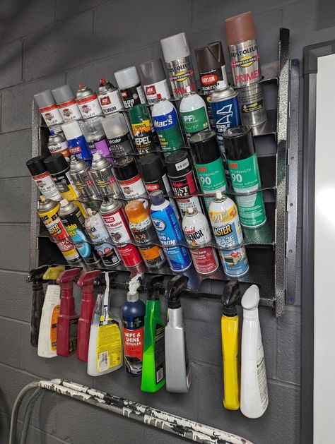 Tired of spray cans and spray bottles accumulating all over your workspace? This is the perfect solution to tidy up your shop. Constructed of a thick gauge steel and optionally powder coated for an ultra durable finish, these racks will outlast your shop! They can be hung on the wall, or freestanding, making them very versatile for any application. Please note that the bottle hangers on the lower shelf will not function if freestanding. We've come up with a variety of different sizes to make sur Spray Bottle Organization, Construction Organization, Farm Equipment Storage, Bottle Organizer, Lumber Storage, Garage Tool Storage, Custom Metal Art, Hanger Organizer, Diy Welding