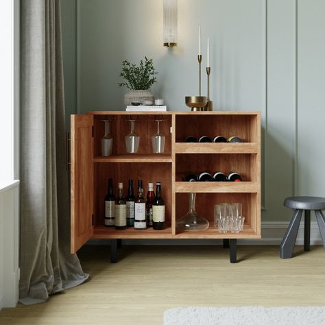 Highly practical, but far from boring, the classic style of this bar and sideboard cabinet is a showstopper that looks great in any space. Your shot glasses and brandy snifters can be stored inside the cabinet that boasts a Shaker style door and adjustable shelf while the hanging stemware holders keep your wineglasses within easy reach. Decanters of your best spirits can reside on the water resistant surface and bottles of your favorite wine will rest on the slanted open bottle shelves. Comprise Closed Bar Cart, Small Tea Bar Ideas, Closed Bar Cabinet, Boho Bar Cabinet, Low Bar Cabinet, Mini Bar At Home Living Rooms, Home Bar Styling, Bar Cart With Mini Fridge, Drink Cabinet Ideas