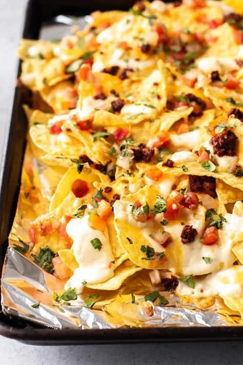 Warm tortilla chips layered with chorizo, creamy cheese sauce, pico de gallo, and cilantro! These Chorizo Nachos are perfect for game day, parties, or any time you're craving a big plate of homemade nachos. Chorizo Nachos, Chorizo Recipes Dinner, Shrimp Appetizers Easy, Creamy Cheese Sauce, Homemade Nachos, Mexican Chorizo, Chorizo Recipes, Quick Chicken Recipes, Favorite Breakfast Recipes