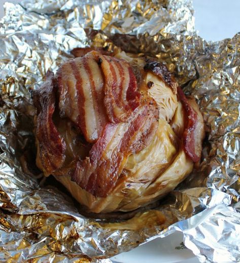 A whole head of cabbage wrapped in bacon and braised in beer is a thing of glory. Make it on the grill or in the oven for a flavorful side dish. Cabbage Recipe On The Grill, Baked Cabbage With Bacon, Cabbage Wrapped In Bacon, Smoked Cabbage In Smoker, Cabbage On The Grill, Grilled Cabbage Recipes, Grilled Sides, Bacon Wraps, Bacon Wrapped Pork Loin