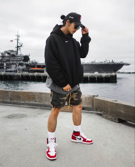 Large hoodie paired with camo shorts and Air jordans 1 mid sneakers Mens Shorts And Hoodie Outfit, Air Jordan Summer Outfit, Air Jordans Outfit Men, Style Jordan 1 Men, Hoodies And Shorts Outfit, Air Jordan 1 Mid Outfit Man, Jordan 1 With Shorts, Air Jordan 1 Outfit Men Fashion Styles, Shorts And Jordans Outfit