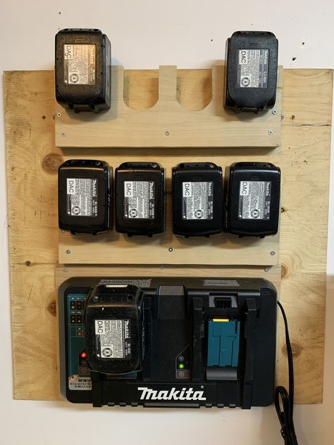 Cheap easy Makita Battery station. Used 1/4" plywood and cut out the U shapes with a band saw then mounted on 3/4" thick stock with 1/2" plywood backer. The U shape is 2 1/8" wide. For the charger I cut a piece of 1/4" plywood slightly larger than the charger and then used #6 wood screws into the rubber feet of the charger Chainsaw Organization, Makita Tool Storage, Battery Charger Station, French Cleat Storage, Workshop Cabinets, Garage Workshop Plans, Garage Organization Tips, Workshop Layout, Garage Furniture