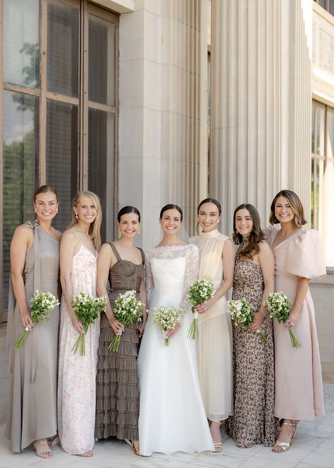 Bridesmaids standing with bride on wedding day wearing mismatched neutral dresses Winter Wedding Mix And Match Bridesmaids, Gold Mix And Match Bridesmaid Dresses, Earthy Neutral Bridesmaid Dresses, Bridesmaids Dresses Earth Tones, Taupe Bridesmaid Dresses Mismatched, Neutral Tone Bridesmaid Dresses, Dark Neutral Bridesmaid Dresses, Wedding Party Neutral Colors, Matching Bridesmaids And Groomsmen