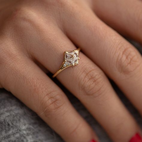 The sculptural design has a 3D effect as five triangle cut diamonds are set to lean against each other all across a polished 18K gold band. Wear this as a striking alternative to the traditional diamond engagement ring. MATERIALS: 18k solid gold | ~0.58 ct Bright White Triangle cut Diamonds | six brilliant-cut diamonds on each side of the setting (~0.08 carats in total) White diamonds parameters: excellent cut, VS clarity, color E-G, conflict-free Band's width: 1.5 mm Available in YELLOW, WHITE Triangle Engagement Ring, Star Engagement Ring, Pretty Engagement Rings, Fine Engagement Rings, Simple Engagement, Ring Inspiration, Cute Engagement Rings, Engagement Ring Inspiration, Buying An Engagement Ring