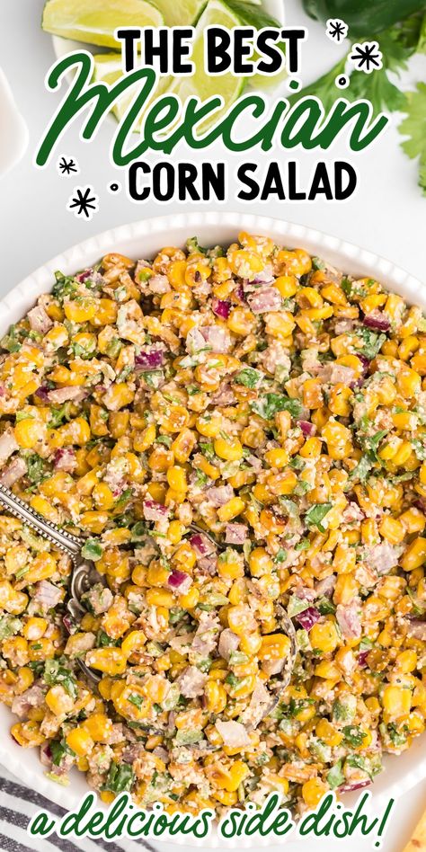 Close-up overhead shot of Mexican corn salad garnished with parsley then topped with Cotija cheese and lime slices. Mexican Corn Salad With Fritos, Corn Cotija Salad, Jalapeno Corn Salad Recipe, Mexican Corn Skillet, Hot Corn Side Dish, Mexican Street Corn Jalapeno Poppers, Corn And Jalapeno Side Dish, Trader Joes Side Dish Recipes, Birria Side Dishes