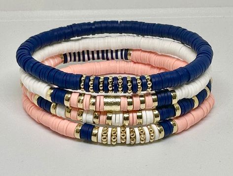 Set of 4 Navy, Light Coral, and White, hand beaded, stretch bracelets. Bracelets are made with 6mm Heishi beads with gold accents. Can customize with wording of your choice using white beads with gold letters. Blue Heishi Bracelet Ideas, Cute Heishi Bracelets Ideas, Heshi Bead Ideas, Bracelets Stacking, Bracelet Heishi, Heishi Jewelry, Navy Bracelet, Womens Gifts, Diy Jewelry Rings