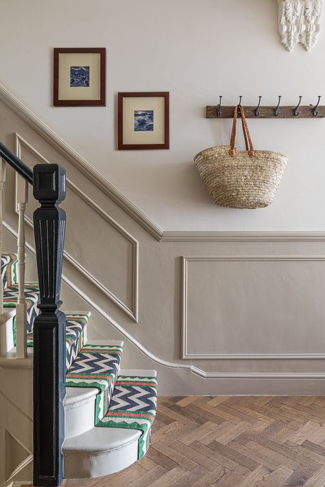 We were tasked with making this house by Clapham Common feel like a home and to reflect our clients' love of life and travel. Stairs And Landing Decor, Lambriseringen Gang, Stairs And Hallway Ideas, Landing Decor, Black Railing, Stair Paneling, Victorian Hallway, Painted Staircases, Hallway Inspiration