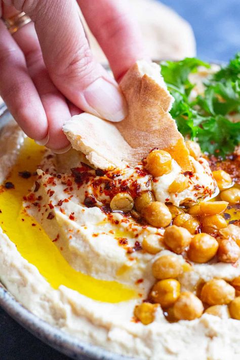 This is the best homemade hummus recipe. With my tips and tricks and how-to video tutorial, you can make the creamiest and smoothest hummus at home that's packed with bright flavors. Hummus is a healthy snack that's vegan and gluten free. It's simple and easy, made with wholesome ingredients. You can have it on a mezze platter, as a sandwich spread or simply as a snack with some pita chips and veggies. #mediterraneandiet #mediterraneanfood #hummus #hummusrecipe #mezze Simple Hummus Recipe, Easy Homemade Hummus Recipe, Beat Hummus Recipe, Spicy Hummus Recipe, Homeade Hummus, Authentic Hummus Recipe Middle East, Best Hummus Recipe, Spicy Hummus, Hummus Recipe Homemade