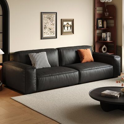 Elevate your living experience with our stunning sofa, where every inch exudes sophistication and comfort. The eye-catching accents, meticulously crafted from genuine leather, add a touch of warmth and elegance to your home. This luxurious fabric boasts a supple touch, rich texture, and natural grain patterns that showcase its authenticity and beauty. The seat and back cushions are meticulously filled with high-density, high-resilience foam, offering unparalleled softness and support. As you sin Black Sofa Interior, Black Leather Couches, Black Modern Sofa, Black Leather Couch, Stunning Sofa, Black Couches, Leather Modular Sofa, Cushion Couch, Faux Leather Sofa