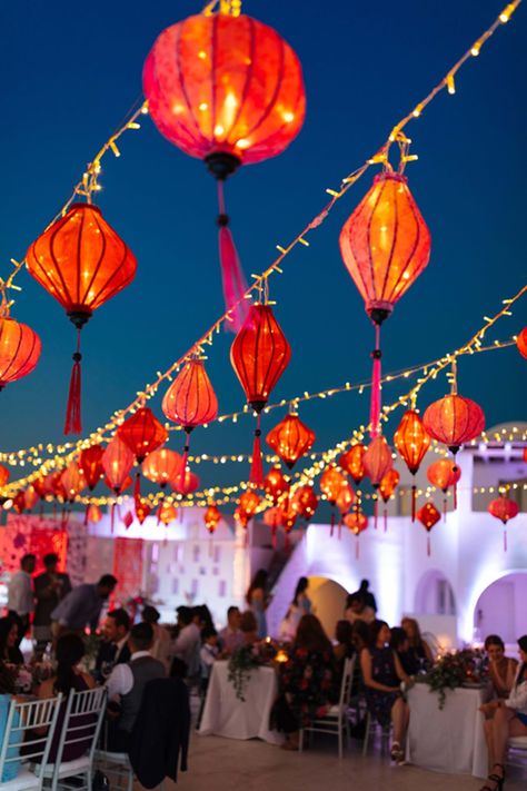 Authentic Chinese character honoring our couple’s tradition with red lanterns hanging over the wedding dinner tables setup |Santorini Wedding Planner & Designer: @mitheoevents Photo: @vangelisphotography Venue: @rocabellasan | #mitheoevents #weddingplannersantorini #destinationweddingsantorini #santoriniwedding #chinesewedding #luxurywedding #seasidewedding #chinoiserie #weddingstyling #weddingdecor #bluewhitewedding #redlanterns #chineselanterns #ambientlighting #weddinglighting Chinese Lanterns Wedding, Dinner Tablescape, Asian Wedding Decor, Chinoiserie Wedding, Chinese Wedding Decor, Asian Inspired Wedding, Lanterns Hanging, Red Lanterns, Lantern Decor Wedding