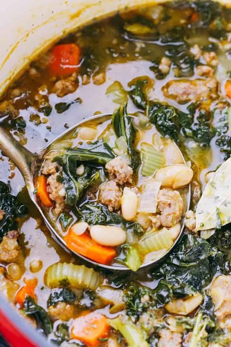 Warm up with this comforting bowl of Italian Sausage Soup, brimming with kale, beans, and flavorful spices. Kale And Beans, Kale And Bean Soup, Escarole Soup, Soup With Kale, Italian Soup Recipes, Kale Soup Recipes, Sausage And Kale Soup, Tuscan Bean Soup, Tuscan Soup