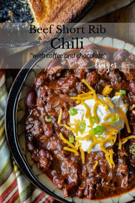 The complexity of flavors in this Beef Short Rib Chili recipe makes it the ultimate comfort food. Dried Ancho and California chile peppers are the keys to its depth and intensity. Chocolate and Coffee, the secret ingredients, add to its richness. Top it off with tender chunks of meat that just about melt in your mouth. #beefchili #beefshortribs Short Rib Chili Slow Cooker, Prime Rib Chili, Rib Chili Recipe, Short Ribs Chili Recipe, Short Rib Chili, Chili Contest, Chili Chili, Comfort Food Chicken, Chile Peppers