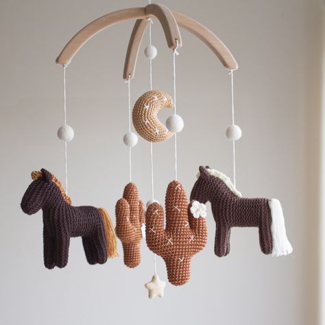 "Our Cowboy / Cowgirl / Horses nursery mobile    * modern, nature and minimalist * made in nature brown/ beige / rust neutral colors * features two horses, two cactuses, moon which are designed in 3D shapes  * makes the perfect accessory for a baby's space and a great gift for a mom-to-be! The hanger of this mobile is two half round arches 10'' in diameter made of untreated solid alder wood.    Total length of the mobile is 16\" (40 cm). Mobile is prepared for hanging it from the ceiling (specia Gender Neutral Nursery Boho Western, Western Theme Nursery Girl, Cowgirl Nursery Ideas, Western Girl Nursery, Horse Nursery Theme, Cowboy Themed Nursery, Horses Nursery, Vintage Cowboy Nursery, Southwest Nursery