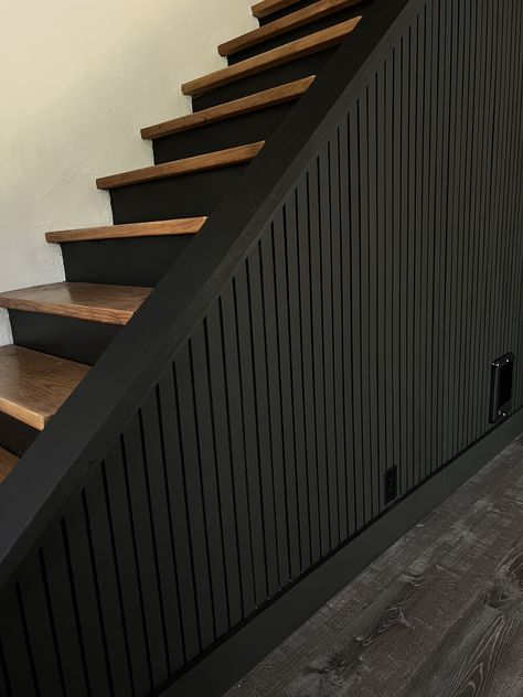 black accent wall tutorial, easy diy, diy project, slat wall, diy slat wall, pole wrap, stairway, moody decor, black wall, diy home projects, black slat wall, modern interior design, moody design, black accent wall, Wood Slat Accent Wall Stairs, Black Feature Wall Staircase, Black Wall On Staircase, Downstairs Wall Ideas, Black Walls With Accent Wall, Black Slat Wall Entryway, Basement Modern Farmhouse, Accent Wall Around Door, Top Of Stairway Decor