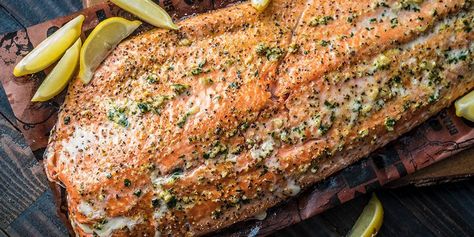 Get hooked on this grilled garlic salmon recipe. Simply brush on a garlic, parsley and olive oil mixture on the filet, toss it on the grill, and let our wood-fired flavor do the rest. Vegetable Cocktails, Smoked Salmon Recipes, Pork Rub, Garlic Salmon, Griddle Recipes, King Salmon, Traeger Recipes, Pellet Grill Recipes, Wood Pellet Grills