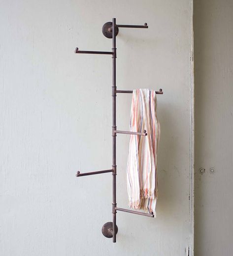 Crafted of solid metal with a rusted finish, this Rustic Wall Swivel Rack adds style to any bathroom, pool house, mudroom, laundry room or covered porch. This rack's metal pipe-like base supports five long hooks that will swivel with ease. Hang hats, towels, jewelry and outerwear on these sturdy hooks. Its distressed design gives the entire piece a rustic farmhouse look. These racks may have slight variations in texture, shape and detail. Indoor or covered outdoor use only. Porch Storage, Hanging Hats, Wall Mount Rack, Small Basements, Coat Rack Wall, Diy Remodel, Wall Racks, Antique Farmhouse, Rustic Wall