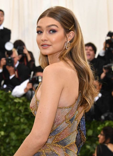 Gigi Hadid at the 2018 Met Gala with long sleek center-parted hair, secured with bobby pins and back-combed at the crown. Gala Hairstyle, جيجي حديد, 2018 Hairstyles, Cute Prom Hairstyles, Hair Tuck, Simple Prom Hair, Classy Hairstyles, Ball Hairstyles, Prom Hairstyles For Long Hair