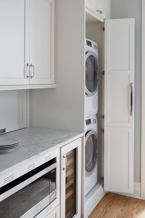 Galley style kitchen featuring hidden stacked washer and dryer in a white cabinet finished with a chrome pull. Hidden Laundry Rooms, Laundry In Kitchen, Hallway Laundry, Grey Laundry Rooms, Stacked Laundry Room, Hidden Laundry, Chicago Vintage, Galley Style Kitchen, Stackable Washer And Dryer