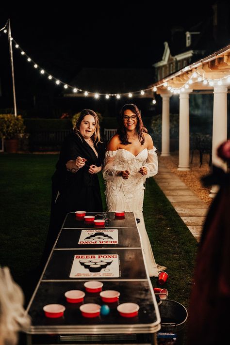 The bride in a beaded floral wedding dress plays beer pong on black shiny table Wedding Diy Activities, Wedding Ideas Alcohol, Fun Wedding Activity Ideas, Cool Ideas For Weddings, Fun Diy Wedding Ideas, Wedding Games Diy, Game Table At Wedding, Fun Wedding Ideas For Guests Party Games, Fun Non Traditional Wedding Ideas