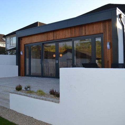 The client approached us to extend existing living area, to create an open-plan space suitable for the whole family. This included the provision of a play room for the kids, and a large outdoor terrace for entertaining. The design took the form of a flat roof extension with a zinc band and a cedar cladding insert, with a large sliding glazed door connecting the new kitchen and dining spaces with the garden beyond. #ZincAndCedar #RearExtensionIdeas #ContemporaryDesign #PatioDesign #FlatRoof Rear Extension Ideas, Flat Roof Extension, Single Storey Extension, Cedar Cladding, Pine Valley, Outdoor Terrace, Roof Extension, Rear Extension, Glazed Door