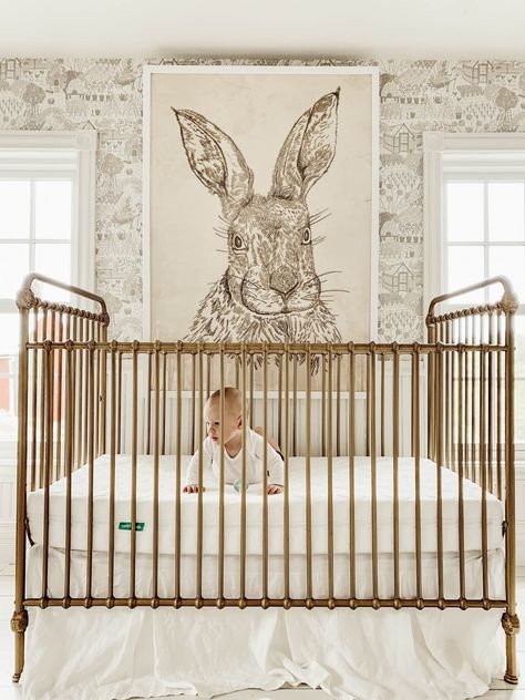 The Best Brass Cribs - Liz Marie Blog Nursery With Metal Crib, Good Crib Nursery, Gold Metal Crib Nursery, Nursery Gold Crib, Whimsical Nursery Neutral, Nursery Ideas Wallpaper, Metal Crib Nursery, Iron Crib Nursery, Art Over Crib