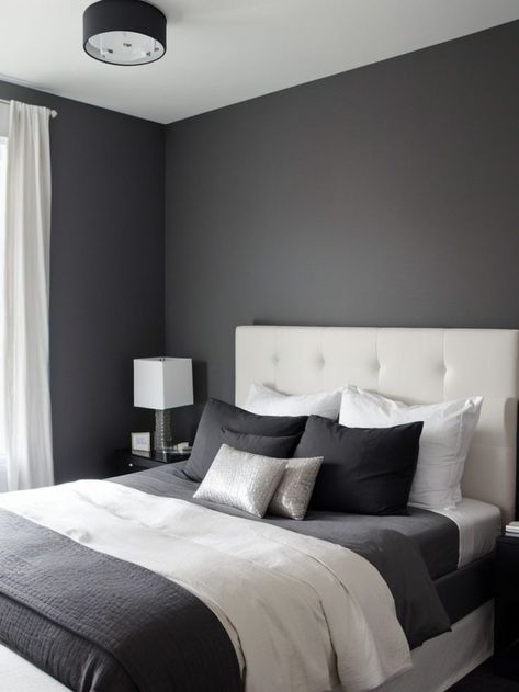 Create a chic and modern bedroom by incorporating a charcoal grey accent wall. Pair it with a sleek platform bed, crisp white bedding, and metallic accents for a sophisticated look. Charcoal Grey Accent Wall, Charcoal Bedroom Walls, Charcoal Grey Walls, Accent Wall Inspiration, Grey Accent Wall, Grey Bedroom Decor, Wall Inspiration, Dark Bedroom, Accent Wall Bedroom