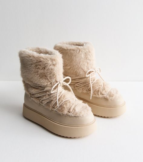 New Look Off White Faux Fur Lined Boots. Soft faux fur make these chunky boots extra cosy. Battle the unpredictable weather in style. They're made with Comfort.  features for a comfy fit that lasts all day. This piece is registered by The Vegan Society and is completely animal free. Material: faux fur Fit: standard Shoe Style: boots Colour: off white Fastening: slip on Toe: round toe Lining: faux fur Design: lace up, chunky sole. Comfort: a range of styles designed with features such as cushione Fur Snow Boots, Wedding Guest Shoes, Faux Fur Boots, Fur Lined Boots, Skirt Co Ord, White Faux Fur, Fur Boots, Chunky Boots, Vegan Shoes