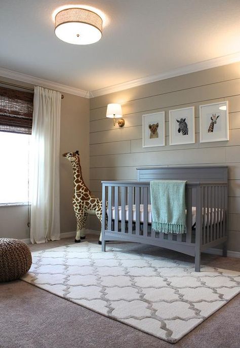 Cozy gray and beige boy's nursery is fitted with gray carpeted floors accented with a Hacienda Park Avenue Trellis Nickel Geometric Area Rug sat beneath a gray Delta Crib positioned beneath three baby animal prints from The Animal Print Shop mounted on a shiplap wall painted in Sherwin Williams Accessible Beige illuminated by a House of Troy Greensboro 13" Pin-up Wall Lamp. Transitional Nursery, Grey Nursery Boy, Baby Boy Bedroom, Shiplap Accent Wall, Baby Boy Room Nursery, Nursery Room Boy, In The Corner, Boy Bedroom, Boys Bedrooms