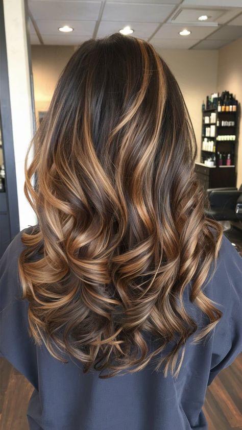 This fall, opt for a glamorous haircut that combines voluminous curls with honey-toned highlights. The layered curls add body and movement, while the honey highlights provide a sun-kissed effect that’s perfect for autumn. Ideal for medium to long hair, this style brings a touch of seasonal flair and elegance, making it a standout choice for the cooler months. Honey Brown Highlights, Fall Haircut, Honey Highlights, Medium To Long Hair, Layered Curls, Fall Hair Cuts, Voluminous Curls, Brown Highlights, Brown Hair With Highlights