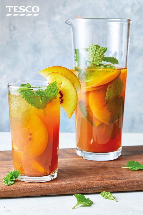 Try a fragrant twist on traditional iced tea with this easy homemade version that uses vanilla chai teabags to add a sweet, spiced flavour. Fresh peaches and mint finish off this refreshing drink in style. | Tesco Chai Iced Tea, Vanilla Chai Tea, Iced Chai Tea, Homemade Iced Tea, Making Iced Tea, Ginger Peach, Peach Ice Tea, Tesco Real Food, Iced Tea Recipes