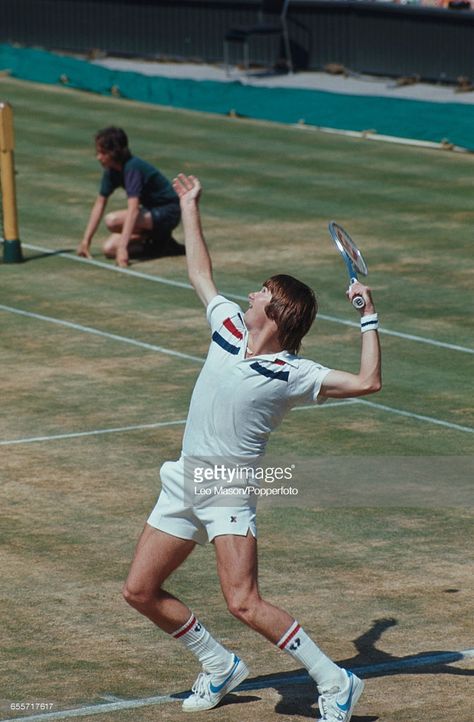 American tennis player Jimmy Connors pictured competing to progress to reach the final of the Men's Singles tournament before losing to Arthur Ashe, 6-1, 6-1, 5-7, 6-4 at the Wimbledon Lawn Tennis Championships at the All England Lawn Tennis Club in Wimbledon, London in July 1975. London In July, Tennis Pics, Jimmy Connors, Tennis Pictures, Tennis Serve, Retro Sportswear, Arthur Ashe, Sports Tennis, Tennis Legends