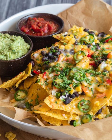 When it comes to game day party grub, these Loaded Vegetarian Nachos are a surefire winner! 🏈 🎉 Layers of crunchy tortilla chips, black beans, corn, bell pepper, red onion, jalapenos, and ooey gooey melty cheese 🧀 come together to create the perfect touchdown-worthy snack! 🙌 Serve these mouthwatering veggie nachos with an array of your favorite dips like sour cream, salsa, and guacamole. 🍅🥑 Comment "nachos" below for the recipe! #SuperBowlFeast #GameDayEats #NachosForTheWin #vegetariannac... Nachos Vegetarian, Veggie Nachos, Salsa And Guacamole, Salsa Nachos, Teenage Party, Vegetarian Nachos, Black Beans Corn, Vegan Nachos, Game Day Party