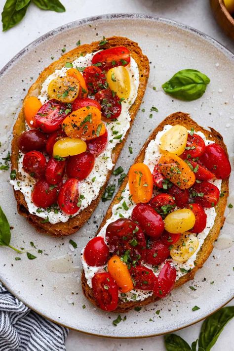 Vibrant Tomato Toast has sweet, juicy tomatoes, garlic, creamy ricotta, and fresh basil layered on a crusty slice of toasted bread. It’s delicious and savory with hints of sweetness. Serve it for breakfast, brunch, as an appetizer, or light lunch for the perfect way to use up summer produce. Tomato On Toast Breakfast, Savory Ricotta Toast, Ricotta And Tomato Toast, Tomato Breakfast Ideas, Basil Breakfast Recipes, Tomato Snack Ideas, Savory Toast Ideas, Tomato Breakfast Recipes, Tomato Basil Sandwich