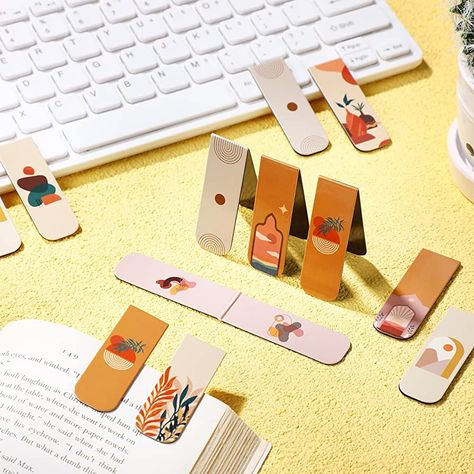 Discover the perfect blend of beauty and function with these magnetic bookmarks! These artistic creations are designed to mark your place in style, featuring vibrant colors and intricate designs that will add a touch of elegance to any book. With their strong magnets and durable materials, they'll keep your page secure while adding a unique and personal touch to your reading experience. #magneticbookmarks #artisticbookmarks #booklovers #reading #bookmarklove Craft Fair Display Table, Plant Bookmark, Home Office Supplies, Magnetic Book, Page Markers, Bookmark Craft, Craft Fair Displays, Unique Bookmark, Book Markers