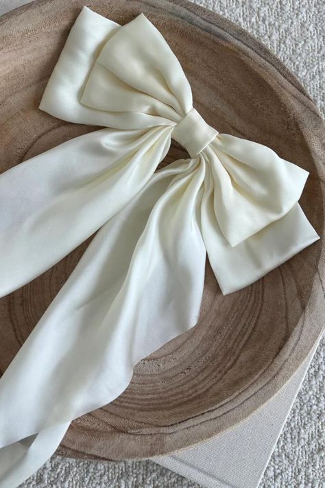 COLOR: Cream As the newest addition to the SB bow collection, the luxe silk bow does not disappoint. This oversized bow elevates and adds a pop to any holiday outfit. DETAILS + CARE: Material: Satin Size: 8.9(L) x 12.6(H) inches Tight, clasping barrette closure Designed with love in San Diego Coquette Stuff, Monica Murphy, Bow Outfit, Girly Vibes, Butterfly Photography, Hair Tie Accessories, Product Shoot, Kawaii Shoes, Casual Outfits For Teens