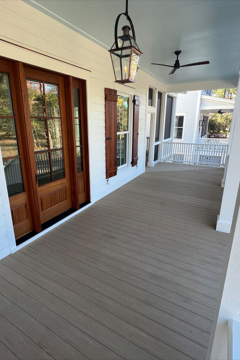 Step into the heart of the Lowcountry on this welcoming front porch, adorned with a classic haint blue ceiling that captures the spirit of tradition and folklore. Discover the magic of outdoor living in the Lowcountry—where porch swings and sweet tea meet under the endless Southern sky. 🏡✨ #LowcountryLiving #FrontPorchCharm #HaintBlueCeiling #GasLanternMagic #CoastalHome #Habersham #SouthernLiving Southern Front Porch, Blue Ceiling, Haint Blue, Porch Floor, Blue Ceilings, Porch Swings, Gas Lanterns, Southern Homes, Design Your Life