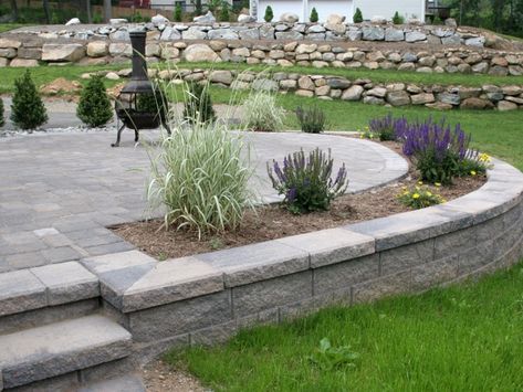 MiraStone Retaining Wall for Backyard Patio Backyard Patio Ideas Pavers Retaining Walls, Retaining Wall Ideas Landscaping, Retaining Wall Ideas With Steps, Elevated Patio With Retaining Wall, Raised Patio Retaining Wall, Raised Back Patio, Raised Garden Around Patio, Concrete Patio Retaining Wall, Concrete Patio Ideas With Retaining Wall