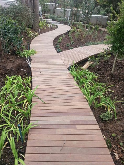 Curved garden walkway by www.prodecking.co.za Wooden Garden Walkway, Wooded Pathway Ideas, Deck Walkway, Wood Walkways Paths, Pathway Landscape Design, Curved Pathway Ideas, Wood Walking Path, Cordwood Pathway, Wood Cookie Pathway