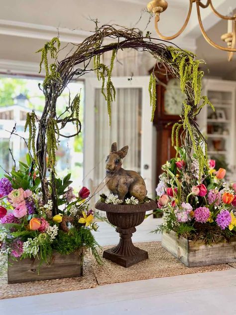 If you're looking for something new and innovative for Easter this year, try a gorgeous fresh spring flower arrangement including an arch. This stunning display is perfect for any Easter celebration and is sure to wow your guests. Learn how to create this look for yourself with all the details in a blog post and youtube video. Willow arch | fresh cut flower arrangement | Easter flower arrangement | Bunny statue with flowers | Bright Spring flowers | Casual garden flower arrangement Large Easter Floral Arrangements, Statue With Flowers, Willow Arch, Easter Plants, Easter Buffet, Easter Outdoor, Easter Floral Arrangement, Basket Centerpieces, Easter Flower Arrangements