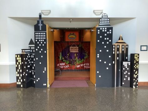 Superhero Office Theme, Vbs Superhero Theme Decorations, Gotham City Themed Party, Superhero Hallway Decorations, Superhero Stage Design, Super Hero Vbs Decorations, Hero Hotline Vbs Decorations, Diy Superhero Decor, Superhero Vbs Decorations