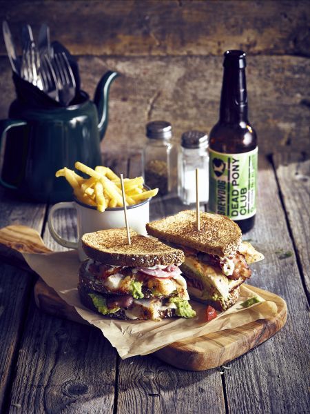 The Classic Club Sandwich, a pub favourite served on a wooden board with a cup of chips Pub Classic Food, Pub Sandwiches, Gastro Pub Food, Pub Chips, Menu Photography, Gastro Pub, Pub Grub, Beer Photography, Gastro Pubs