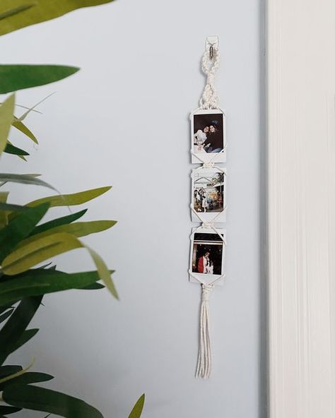 Knotted by Ash on Instagram: "another new product, polaroid wall charm✨ put all your adorable polaroids on full display anywhere around the home! These will be coming to Etsy on Sunday☺️ #macrame #polaroid #instaxmini #polaroidholder #polaroidframe #macramedesign #macramehome #homedecor #bohostyle #bohodecor #bohohome #handmadegifts #handmadehome #fiberart #fiberartist #etsyhamilton #etsyca #etsyniagara #shopsmall #shoplocalcanada #shopcanadian #supportsmallbusiness #supportlocalbusiness #macra Hanging Polaroid Pictures, Diy Polaroid Display, Macrame Picture Holder, Macrame Photo Hangers, Crochet Polaroid Frame, Macrame Photo Frame, Macrame Crafts, Picture Holder Diy, Macrame Polaroid Holder Diy