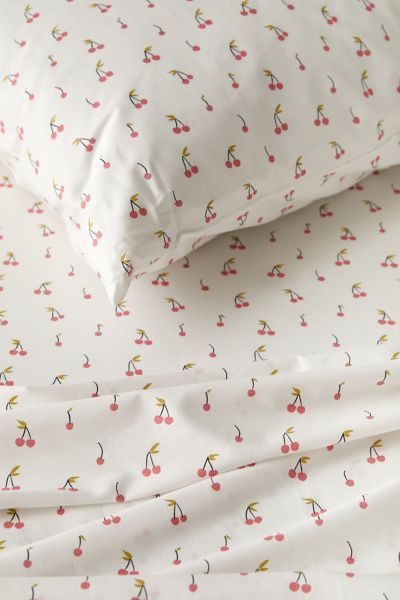 Slip into the sweetest dreams when you wrap yourself in this sheet set featuring bunches of red cherries printed allover that lends a retro-cool touch to your bed. Printed on a woven cotton blend that feels so silky smooth against your skin. Available in sizes Twin XL, Full, Queen and King, each set includes a flat sheet, fitted sheet and pillowcases. Pair with other bedding favorites from UO Home to create a unique bedding space of your own. Only at Urban Outfitters. Features Retro-femme cherry Cherry Bedding, Spring Bedding Sets, Red Dorm, Dorm Sheets, Cherry Bed, Cute Bed Sheets, Spring Bedding, Cherry Bedroom, Sweetest Dreams