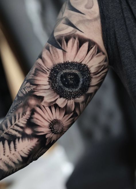 Black and gray sunflower and daisy tattoo Daisy Flower Tattoos Men, Masculine Daisy Tattoo, Men Sunflower Tattoo, Sunflower And Daisy Tattoo, Black And Grey Sunflower Tattoo, Black And Gray Sunflower Tattoo, Daisy Sleeve Tattoo, Ferns Tattoo, Flower Tats