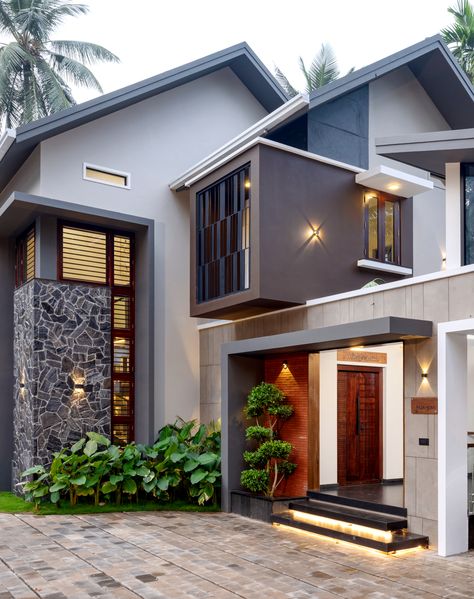 Designed by Zherow Architects, Faza Home is located in the town of Vadakara, Kerala. With a site area of 17 Cents and a built-up area of 3150 sq.ft, the 4-bedroom residence- Faza Home designed with a minimalist style exuding luxury and elegance. The brief given by the client was to design a home that was open and facilitated natural ventilation into all areas. Architectural Render, House Models, Brick Houses, Handrail Design, Kerala House, The Architects Diary, Front Elevation Designs, Wardrobe Handles, Bungalow Design