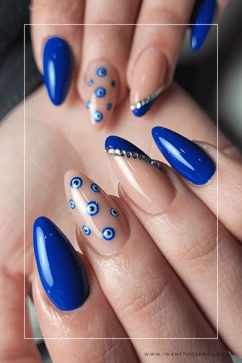 Achieve both style and protection by taking inspiration from these royal blue evil eye nails! This captivating nail art is not only highly fashionable but also believed to keep away negative energies. Get creative with different designs or simply go for an alluring single accent nail - stay glamorous while embracing positive vibes! Gel Nail Designs Royal Blue, Protection Eye Nails, Blue Eye Nail Art, Nail Art Evil Eye Design, Evil Nail Designs, Evil Eye Nail Art Design, Blue Nails With Evil Eye, Royal Blue Nail Art Design, Nail Art Blue Electric